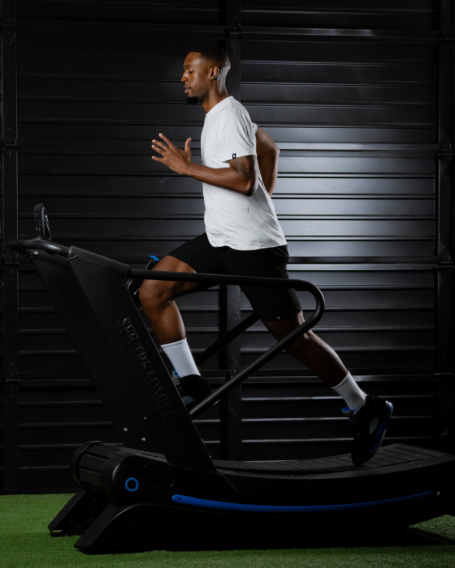 ALL IN ALL model running on a treadmill wearing an off-white supernatural bamboo tee and black supernatural shorts.