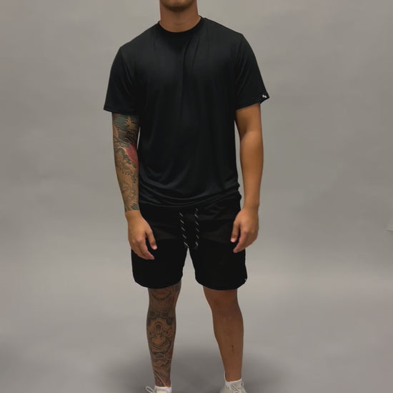 Male modeling ALL IN ALL Supernatural black bamboo shirt and black shorts