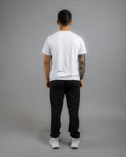 Backside of model wearing the ALL IN ALL SUPERNATURAL II JOGGER in black and Supernatural Bamboo shirt in off white