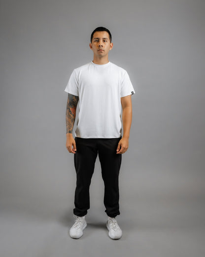 model facing forward wearing ALL IN ALL off-white supernatural bamboo tee with black supernatural II jogger