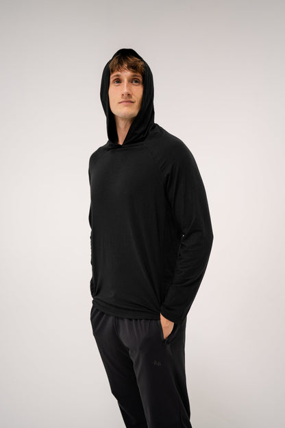 Male model wearing an ALL IN ALL black hoodie and ALL IN ALL black joggers against a white background