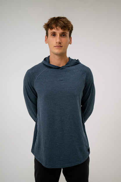 Male model wearing an ALL IN ALL heather blue hoodie against a plain background