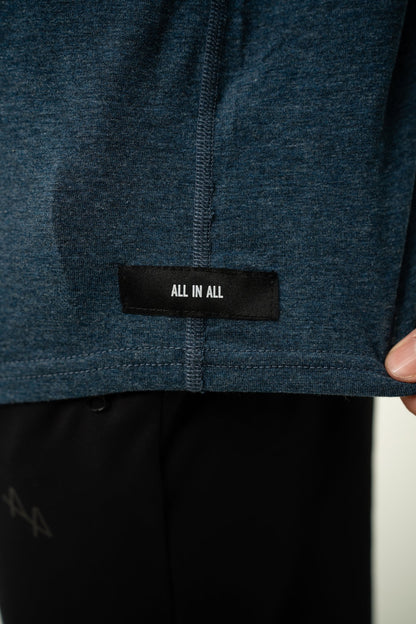 Close-up of ALL IN ALL heather blue hoodie with a black 'ALL IN ALL' label.