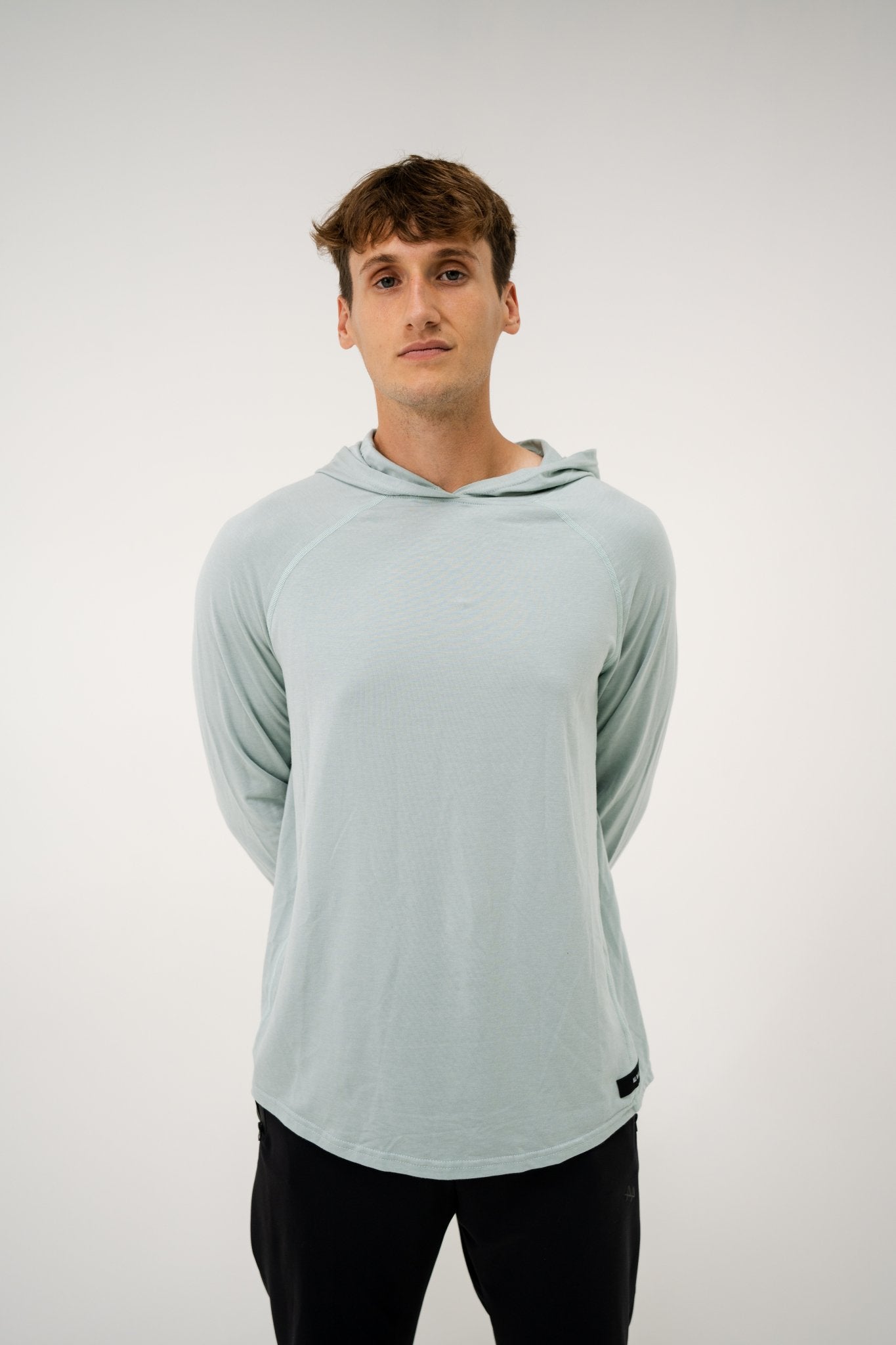 Male model wearing an ALL IN ALL mojito hoodie on a white background