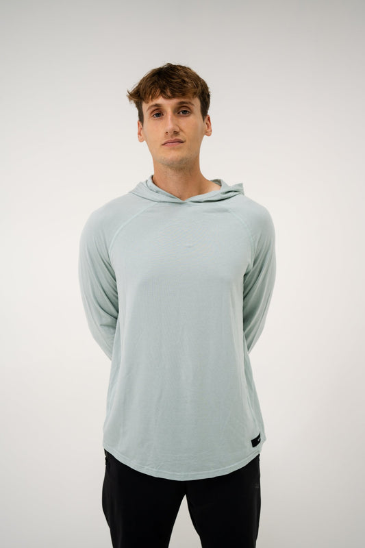 Male model wearing an ALL IN ALL mojito hoodie on a white background